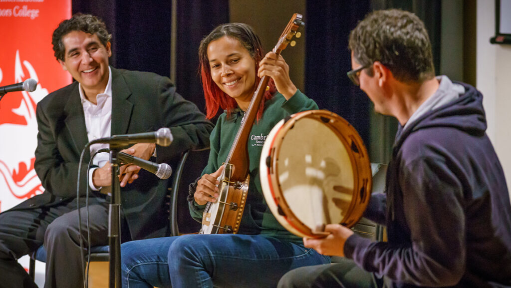 Dr. Omar Ali (left) with Rhiannon Giddens (center) playing banjo at UNCG.